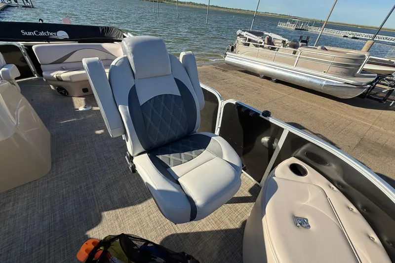 Slide: The Image of Captain's chair on 2018 SunCatcher V20 Fish pontoon boat, docked by the water. - 29