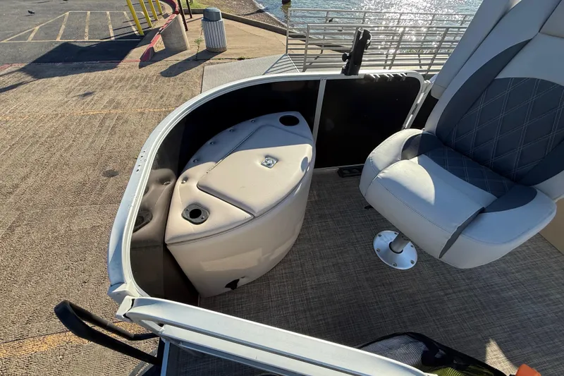 Slide: The Image of 2018 SunCatcher V20 Fish boat interior with seating and storage, dockside view. - 31