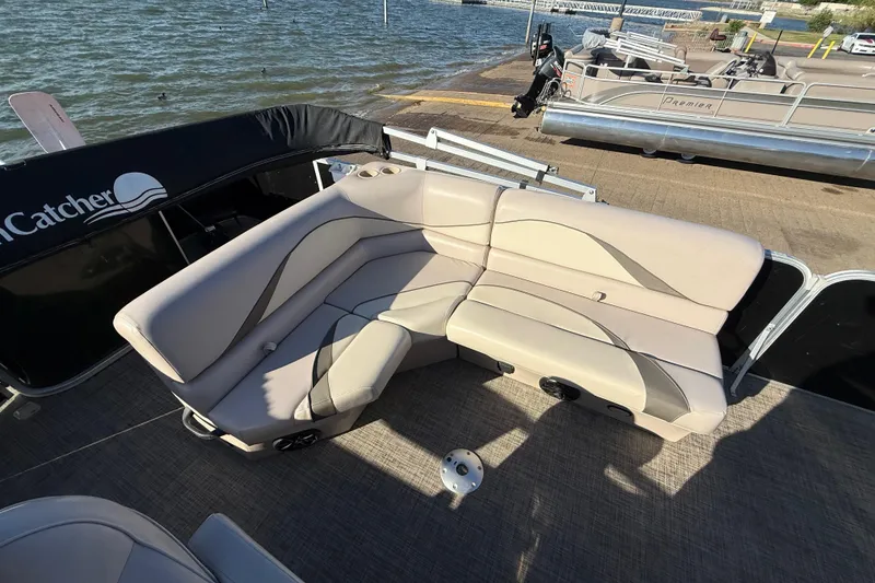 Slide: The Image of 2018 SunCatcher V20 Fish boat with beige seating, docked by the water. - 35