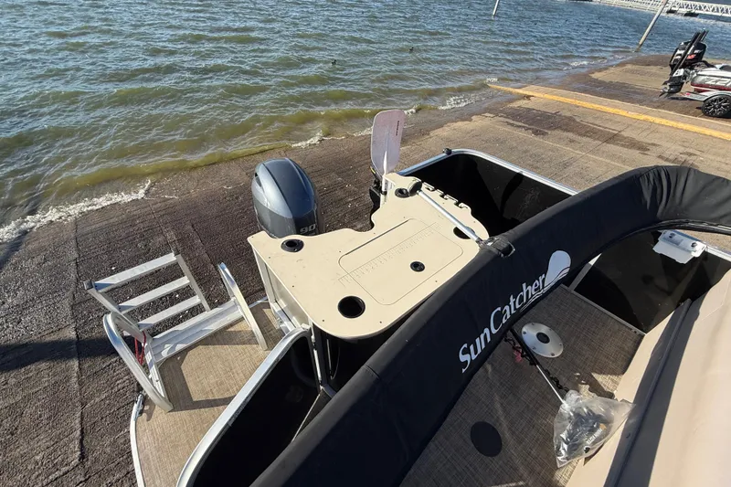 Slide: The Image of 2018 SunCatcher V20 Fish boat at dock with outboard motor and fishing setup. - 37