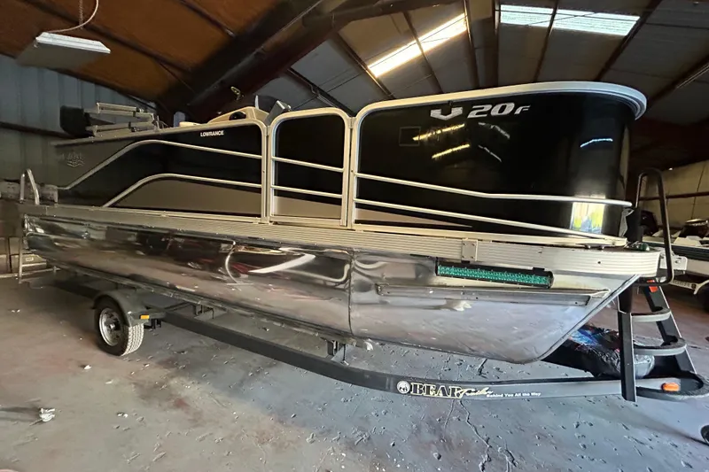 Slide: The Image of 2018 SunCatcher V20 Fish pontoon boat in a storage facility. - 4