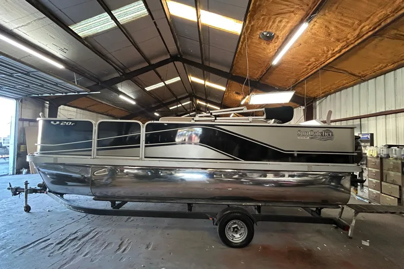 Slide: The Image of 2018 SunCatcher V20 Fish pontoon boat in a warehouse setting. - 5