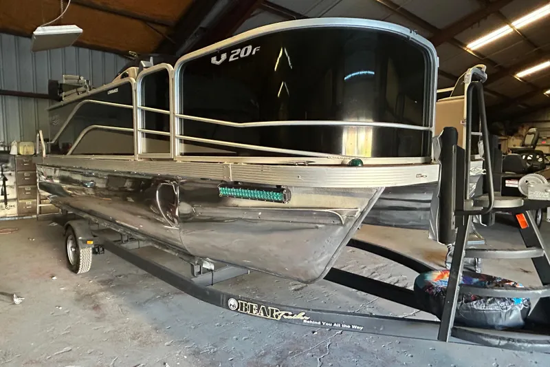 Slide: The Image of 2018 SunCatcher V20 Fish pontoon boat on trailer in a garage setting. - 6