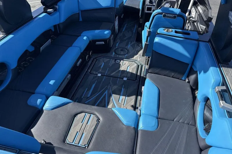Slide: The Image of Luxurious blue and black interior of 2021 Supra SA 450 boat, featuring spacious seating. - 10