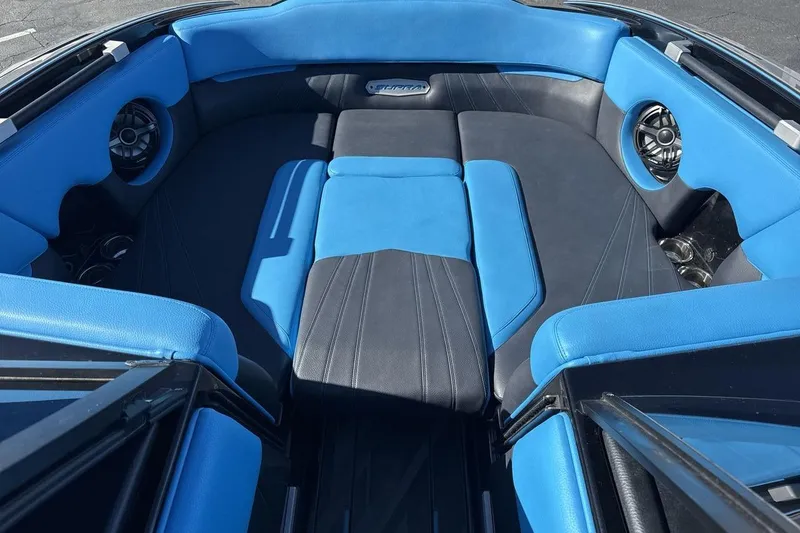 Slide: The Image of 2021 Supra SA 450 boat interior with blue and black seating, featuring built-in speakers. - 11