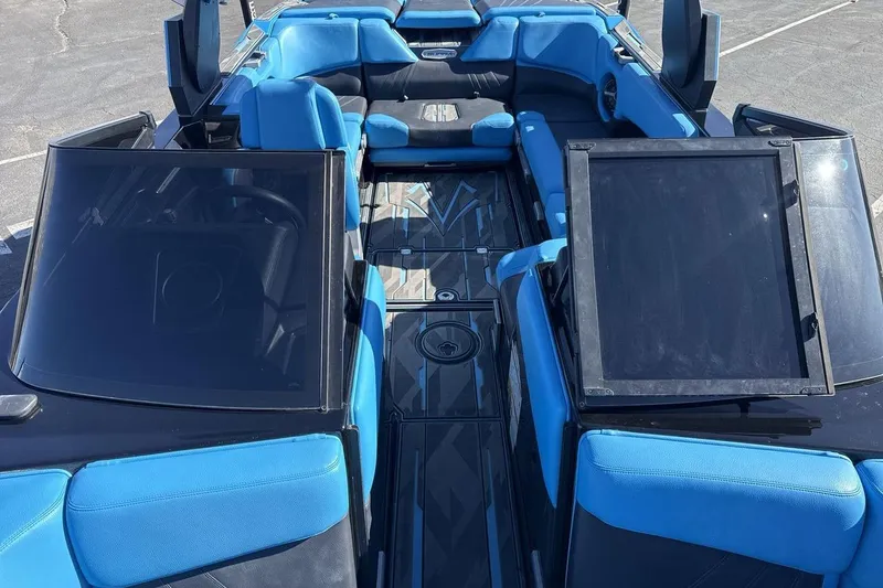 Slide: The Image of 2021 Supra SA 450 boat interior with blue and black seating, open cockpit view. - 12