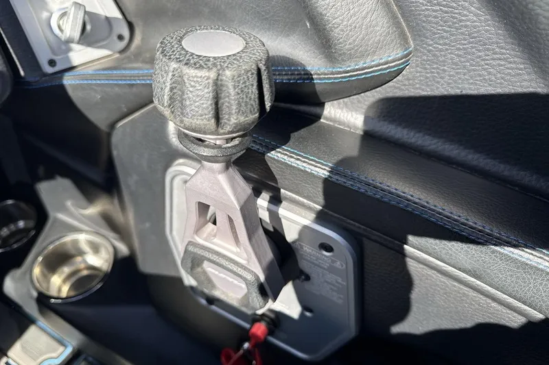 Slide: The Image of Close-up of 2021 Supra SA 450 boat throttle control with black and blue stitching. - 16