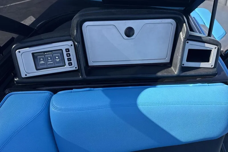 Slide: The Image of 2021 Supra SA 450 boat dashboard with control panel and blue seating. - 18