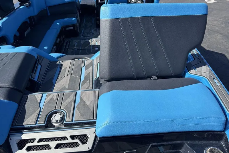 Slide: The Image of 2021 Supra SA 450 boat interior with blue and black seating, modern design. - 19