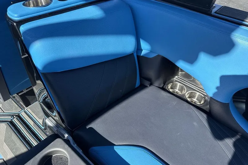 Slide: The Image of Blue and black interior seating of 2021 Supra SA 450 boat with cup holders. - 24