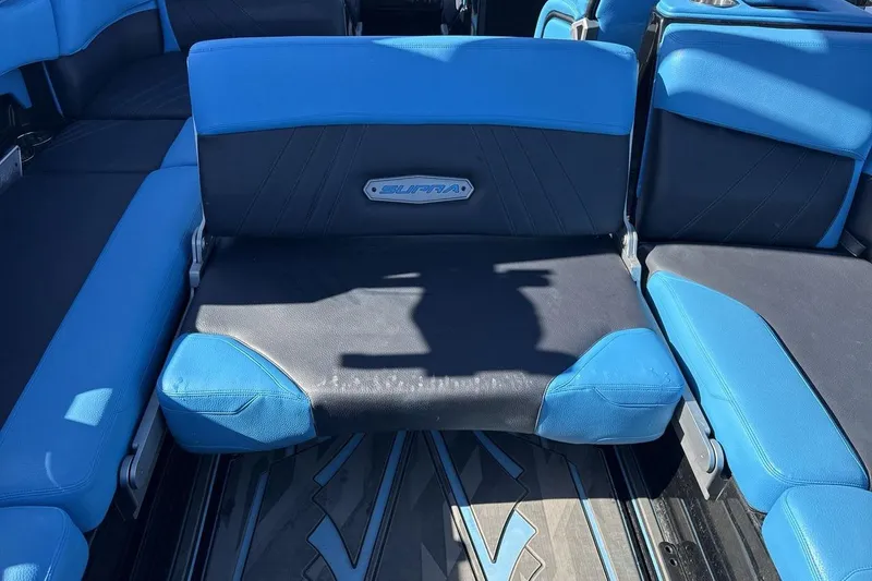 Slide: The Image of 2021 Supra SA 450 boat interior with blue and black seating. - 25