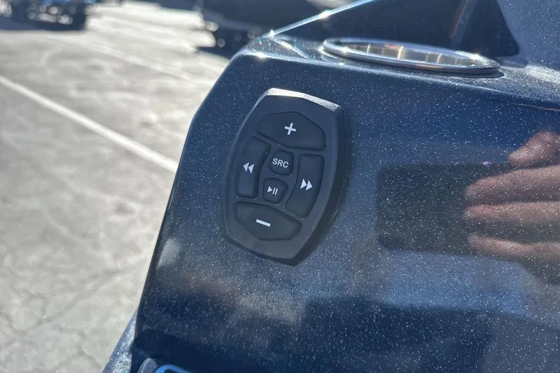Slide: The Image of Close-up of 2021 Supra SA 450 boat control panel with audio buttons. - 27