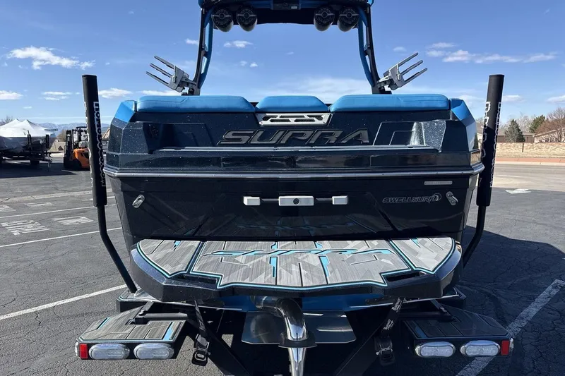 Slide: The Image of 2021 Supra SA 450 boat rear view in parking lot, showcasing sleek design and branding. - 4