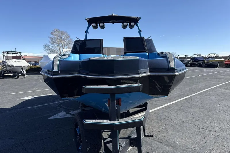 Slide: The Image of 2021 Supra SA 450 boat on trailer in parking lot under clear blue sky. - 8