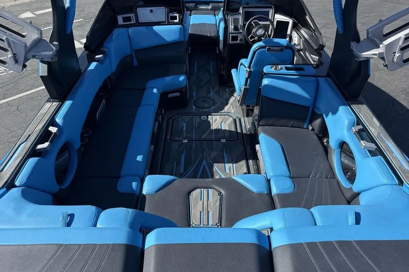 Slide: The Image of 2021 Supra SA 450 boat interior with blue and black seating, modern design. - 9