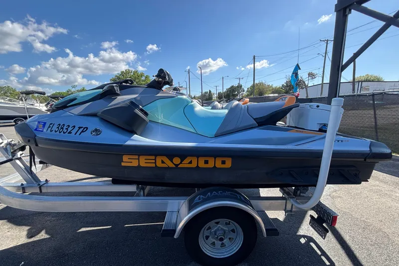 Slide: The Image of 2023 Sea-Doo GTI 130 jet ski on trailer under clear blue sky. - 10