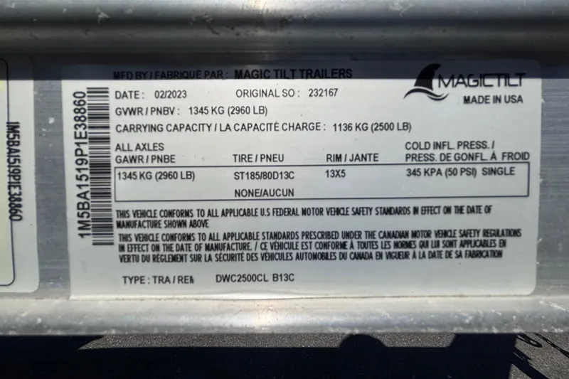 Slide: The Image of Label on Magic Tilt trailer, detailing specifications and compliance standards. - 13