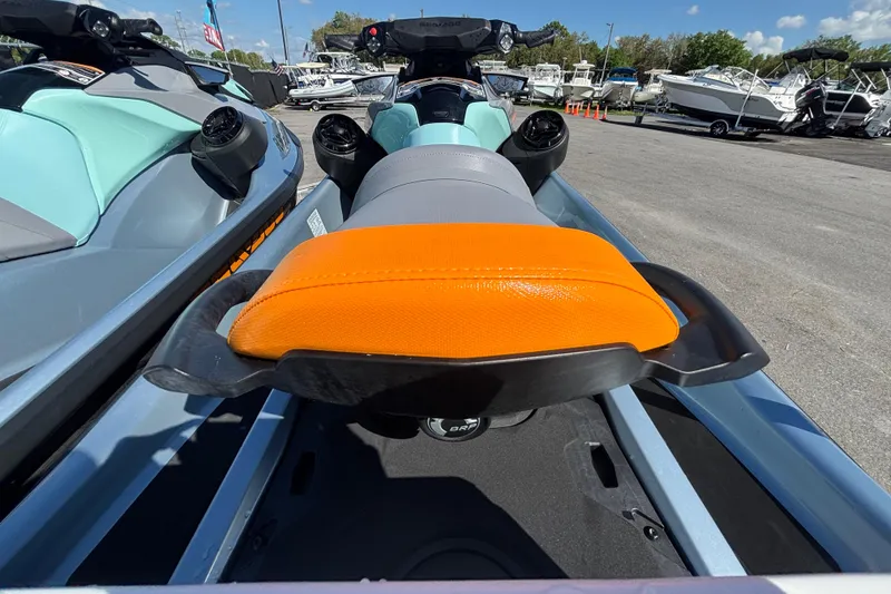 Slide: The Image of 2023 Sea-Doo GTI 130 jet ski with orange seat, parked outdoors. - 20