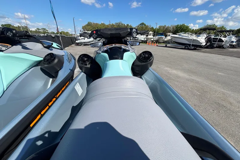 Slide: The Image of 2023 Sea-Doo GTI 130 jet ski in a marina under a clear blue sky. - 22