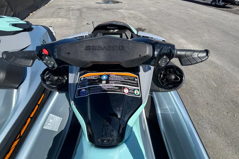 Slide: The Image of 2023 Sea-Doo GTI 130 handlebars and dashboard, showcasing controls and warning labels. - 25