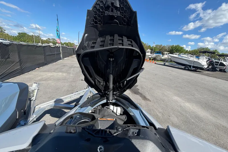 Slide: The Image of 2023 Sea-Doo GTI 130 with open hood, showcasing internal components, parked outdoors. - 26