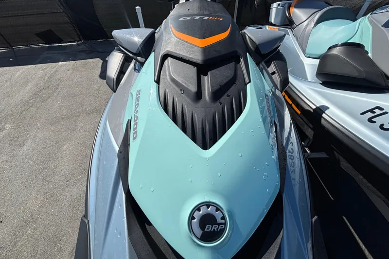 Slide: The Image of 2023 Sea-Doo GTI 130 jet ski, sleek design, parked outdoors. - 31