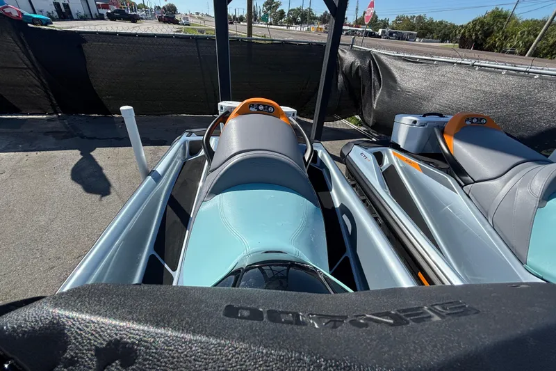 Slide: The Image of 2023 Sea-Doo GTI 130 jet ski parked outdoors, showcasing sleek design and seating. - 33
