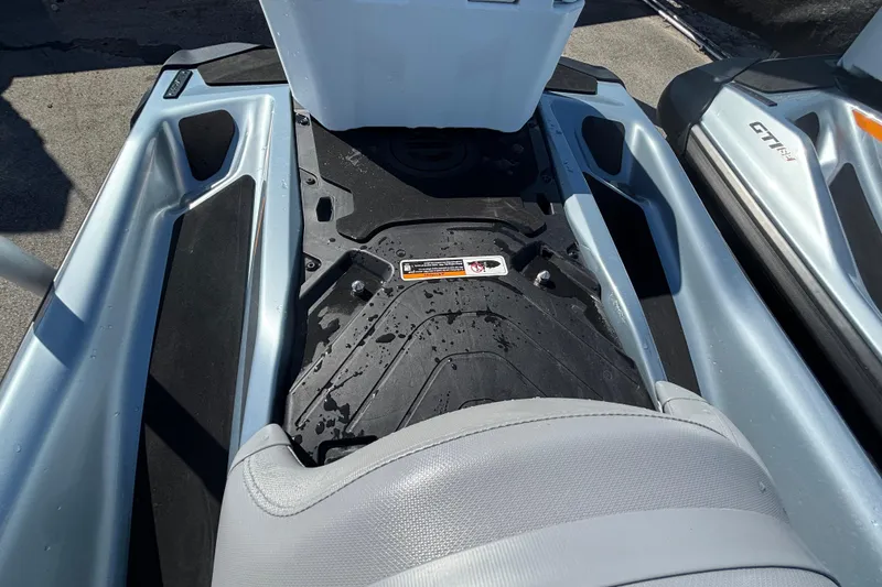 Slide: The Image of 2023 Sea-Doo GTI 130 footwell and seat detail, showcasing sleek design and wet surface. - 36