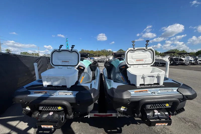 Slide: The Image of 2023 Sea-Doo GTI 130 jet skis with open storage compartments, parked under a clear blue sky. - 41