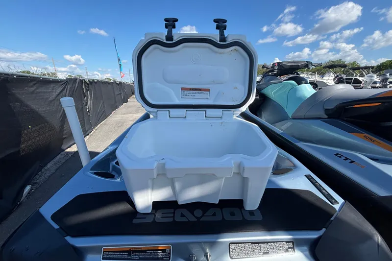 Slide: The Image of 2023 Sea-Doo GTI 130 with open storage compartment, under clear blue sky. - 42