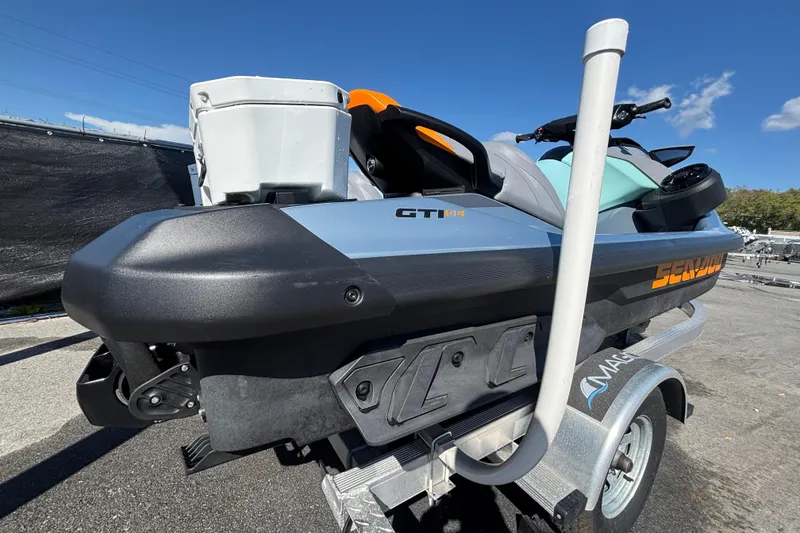 Slide: The Image of 2023 Sea-Doo GTI 130 jet ski on trailer under clear blue sky. - 5