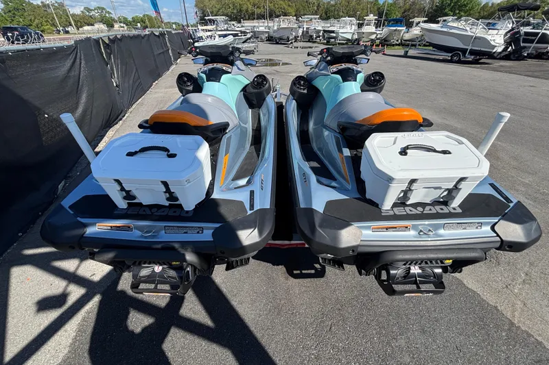 Slide: The Image of 2023 Sea-Doo GTI 130 jet skis parked, featuring storage boxes and sleek design. - 6