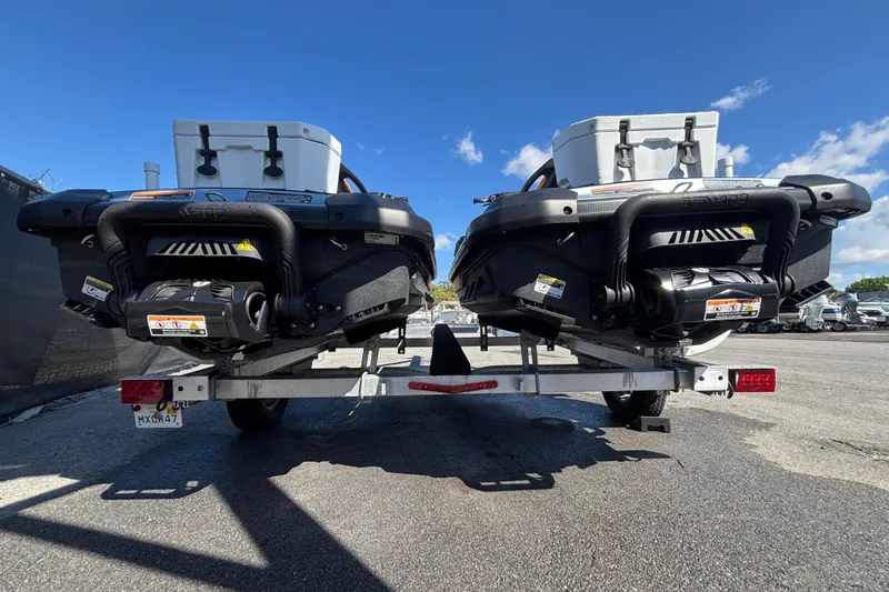 Slide: The Image of 2023 Sea-Doo GTI 130 jet skis on trailer, rear view, sunny day. - 8