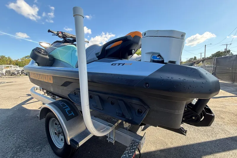Slide: The Image of 2023 Sea-Doo GTI 130 jet ski on trailer under clear blue sky. - 9
