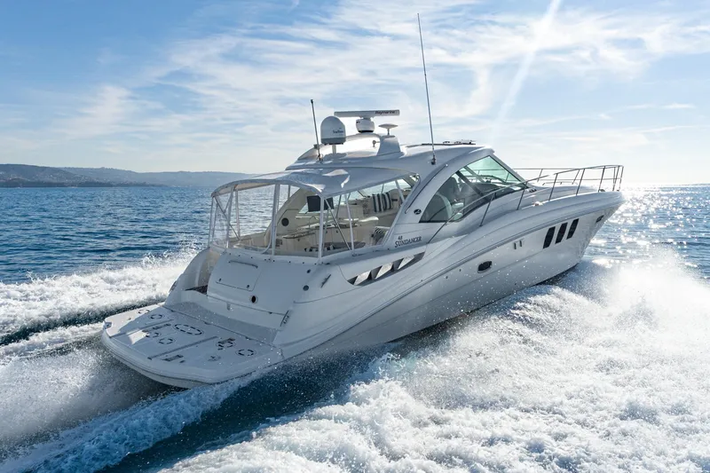 Slide: The Image of 2005 Sea Ray 480 Sundancer yacht cruising on open sea. - 13