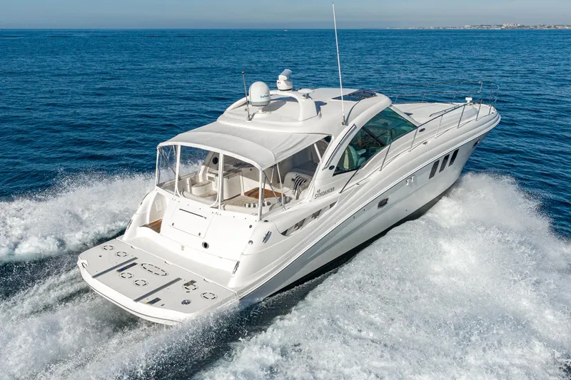 Slide: The Image of 2005 Sea Ray 480 Sundancer yacht cruising on open sea. - 2