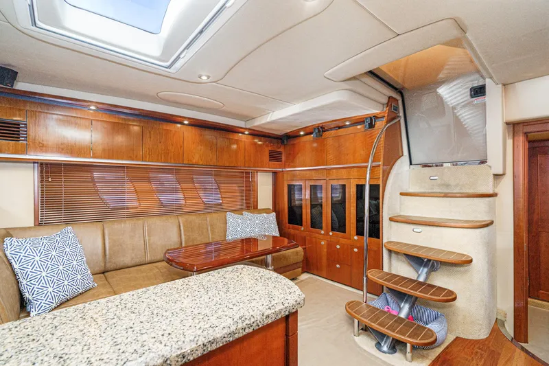 Slide: The Image of Interior of a 2005 Sea Ray 480 Sundancer yacht with elegant wood paneling. - 43