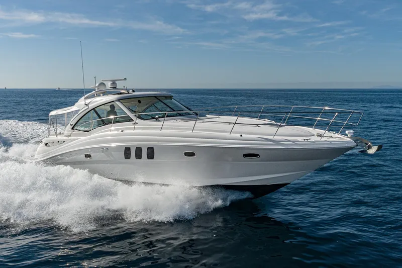 Slide: The Image of 2005 Sea Ray 480 Sundancer yacht cruising on open sea. - 5