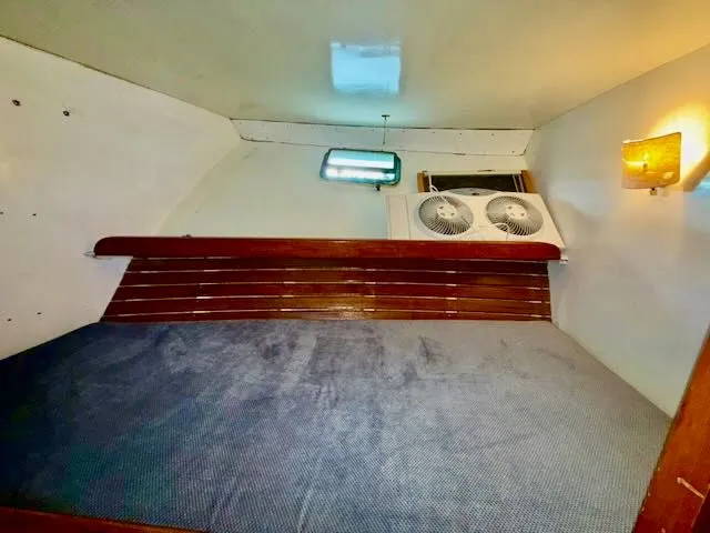 Slide: The Image of Interior of 1982 Rough Water 41 Pilothouse with bed and fan. - 11