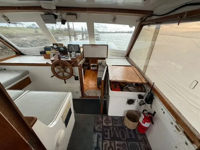 Slide: The Image of Interior of 1982 Rough Water 41 Pilothouse with helm and seating area. - 20