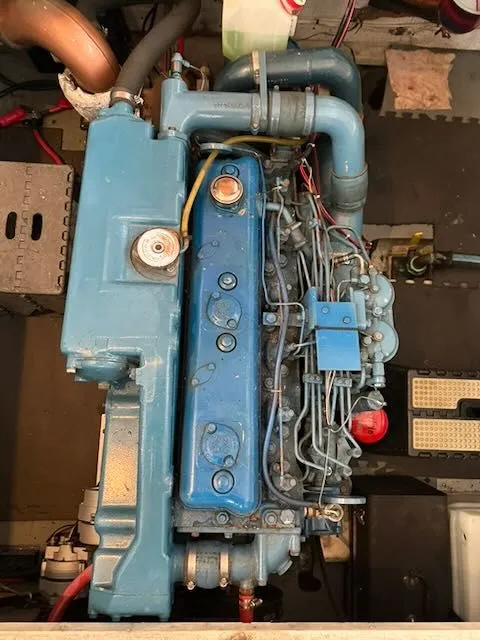 Slide: The Image of Engine room of a 1982 Rough Water 41 Pilothouse boat with blue machinery. - 27