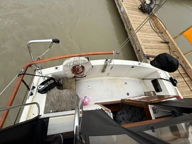 Slide: The Image of Inflatable dinghy with outboard motor docked at a wooden pier. - 34