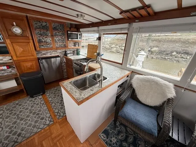 Slide: The Image of Interior of 1982 Rough Water 41 Pilothouse yacht with kitchen and seating area. - 7