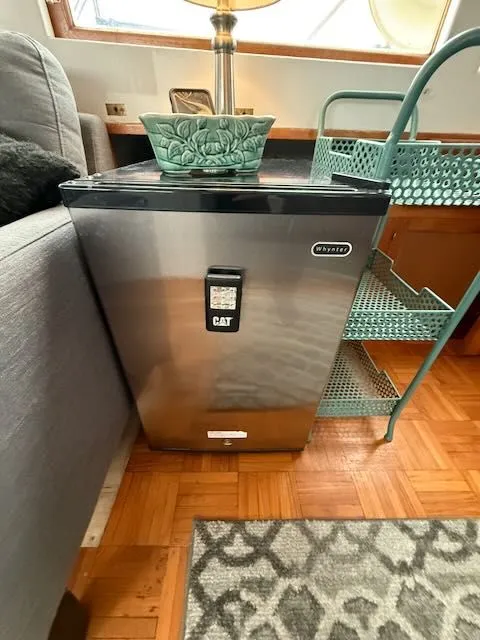 Slide: The Image of Compact fridge beside sofa on Rough Water 41 Pilothouse, year 1982. - 9