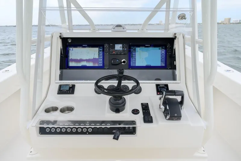 Slide: The Image of 2024 SeaVee 370Z boat dashboard with navigation screens and controls on open water. - 10
