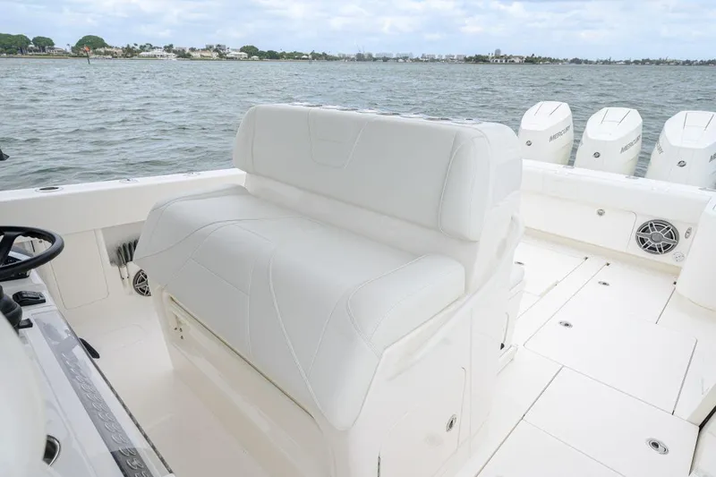 Slide: The Image of 2024 SeaVee 370Z boat interior with white seating and multiple outboard engines. - 13