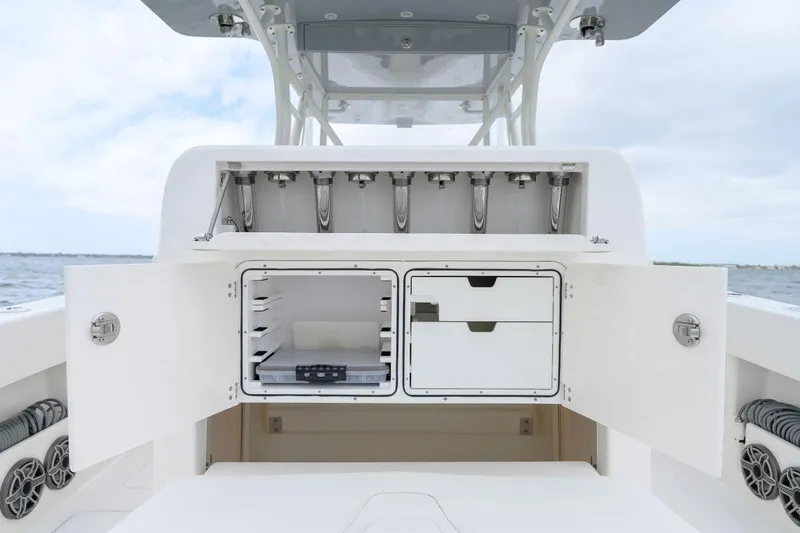 Slide: The Image of 2024 SeaVee 370Z boat storage compartments open, showcasing organized interior space. - 14