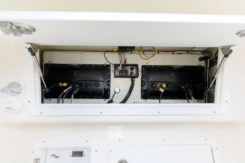 Slide: The Image of 2024 SeaVee 370Z electrical compartment with wiring and components. - 19