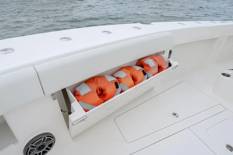 Slide: The Image of 2024 SeaVee 370Z boat with life jackets stored in a compartment. - 21