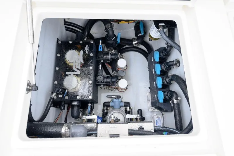 Slide: The Image of 2024 SeaVee 370Z boat compartment showcasing intricate plumbing and mechanical systems. - 24
